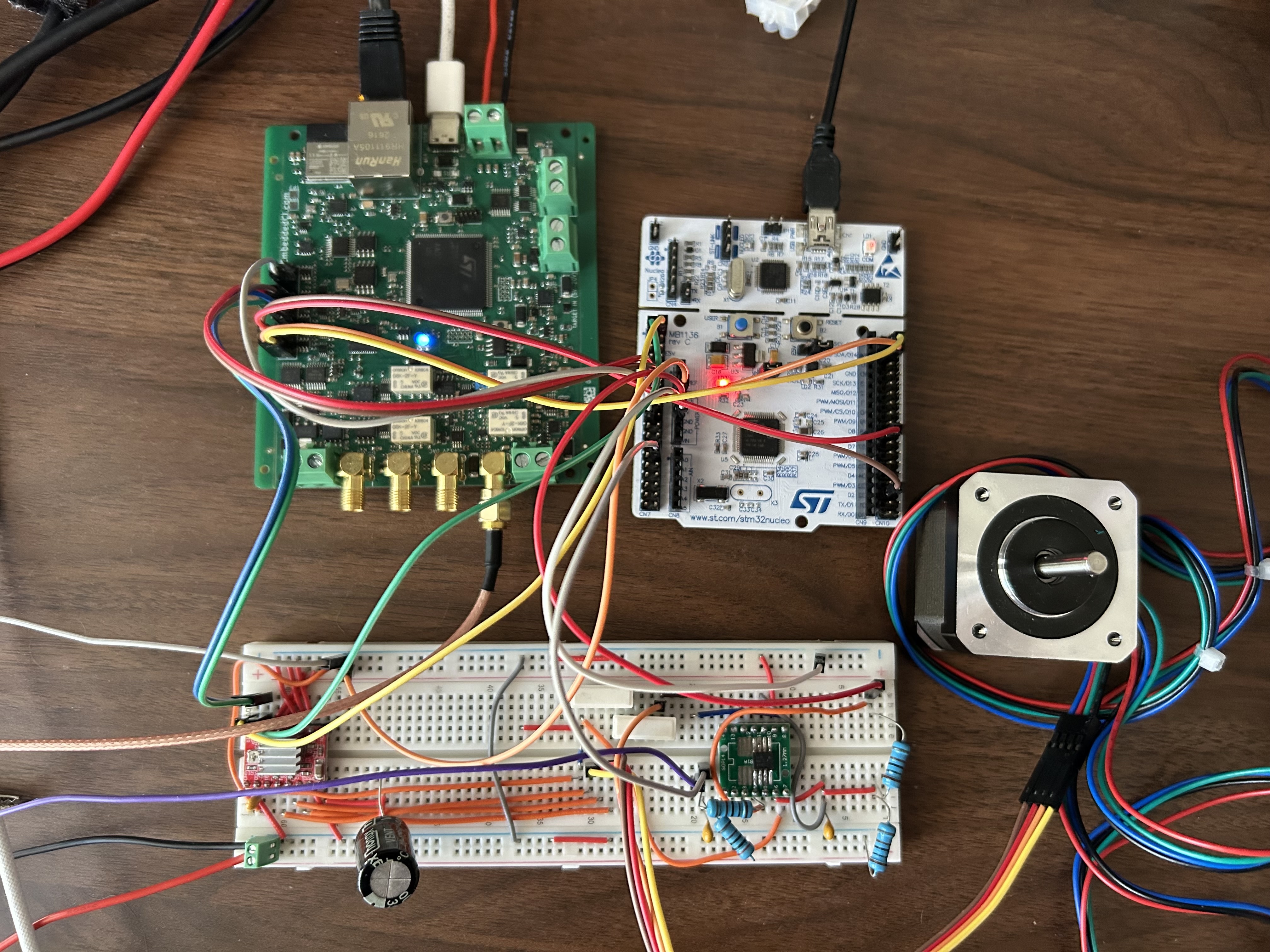 A BenchPod wired to an STM32 development board driving a real NEMA stepper — the logic-analyzer channels watch STEP/DIR while the analog front-end measures coil current through a shunt
